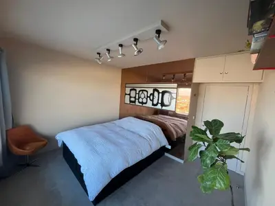 a bedroom with a bed and a plant in it at Apartments overlooking Brussels in Brussels