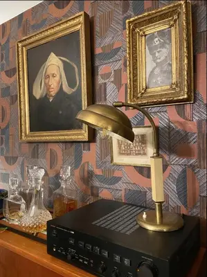 a desk with a lamp and a picture of a woman at Apartments overlooking Brussels in Brussels