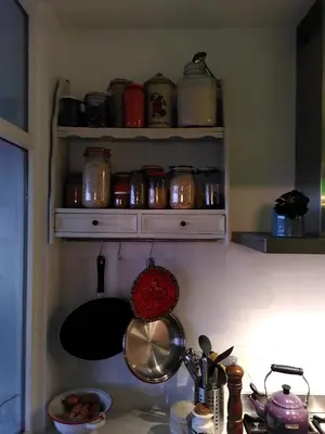 a kitchen counter with pots and pans on a shelf at Apartments overlooking Brussels in Brussels