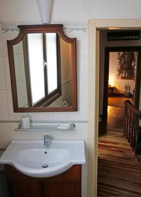 a bathroom with a sink and a mirror and a hallway at 18de-eeuwse woning in het hartje van Gent in Ghent