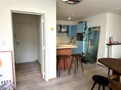 a kitchen with a table and stools in a room at Studio downtown Gent in Ghent