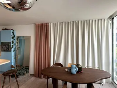 a living room with a table and a curtain at Studio downtown Gent in Ghent