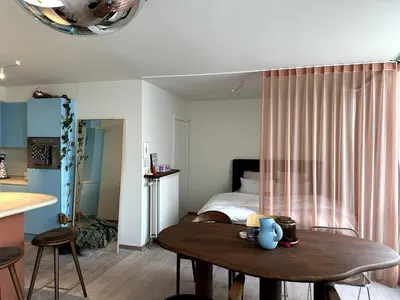 a bedroom with a bed and a wooden table at Studio downtown Gent in Ghent