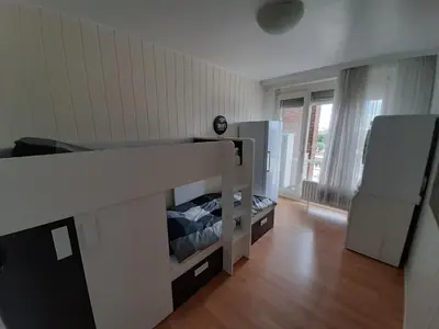 a bedroom with a bunk bed in a room at Mazzimmo Boom in Boom