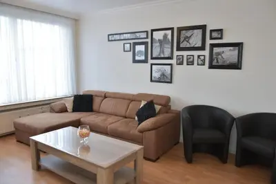 a living room with a couch and a table at Mazzimmo Boom in Boom