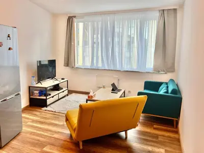 a living room with a couch and a television at Design Studio Brussels Madou in Brussels