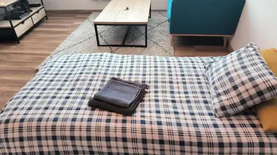 a blanket with a purse sitting on top of it at Design Studio Brussels Madou in Brussels