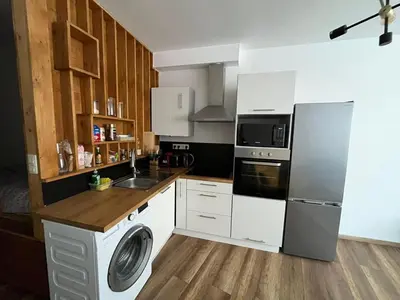 a kitchen with a refrigerator and a washing machine at Design Studio Brussels Madou in Brussels