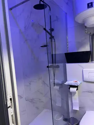 a shower with a glass door in a bathroom at Design Studio Brussels Madou in Brussels