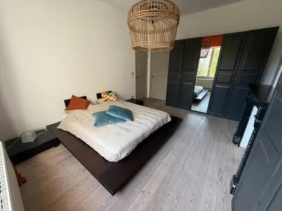 a bedroom with a bed and a chandelier at Dock Suites in Ghent