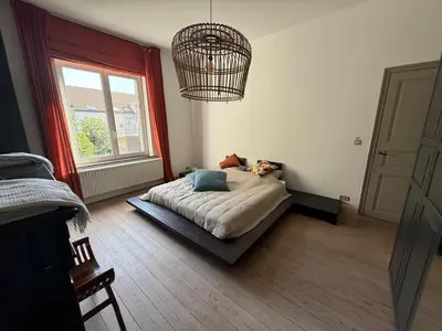 a bedroom with a bed and a window at Dock Suites in Ghent