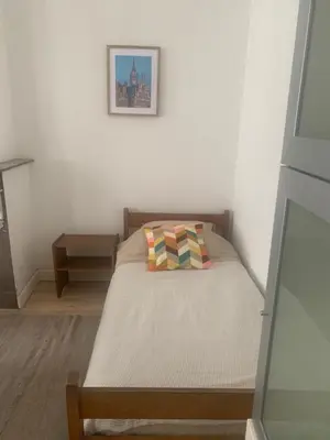 a bedroom with a bed with a pillow on it at Dock Suites in Ghent