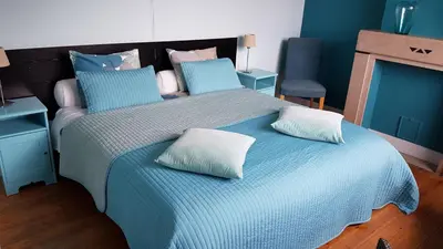 a bedroom with a blue bed with two pillows on it at B&B Lieven Bauwens in Ghent