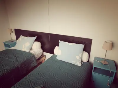a small bedroom with two beds and two lamps at B&B Lieven Bauwens in Ghent