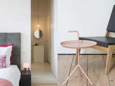 a bedroom with a pink table next to a bed at B&B Pastorie Balegem in Balegem