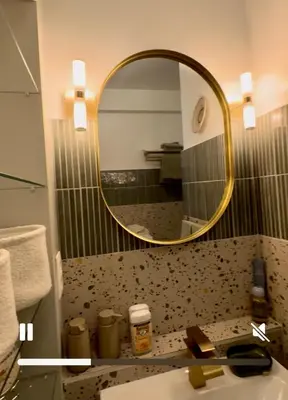 a bathroom with a sink and a mirror on the wall at Sunflora Apartment in Brussels