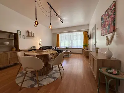 a living room with a table and chairs at Sunflora Apartment in Brussels
