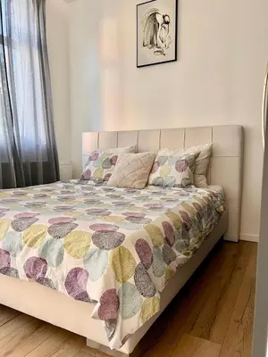 a bed with a comforter and pillows in a bedroom at Bruxnord BnB in Brussels
