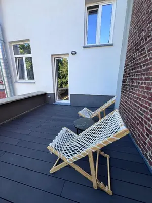 a pair of chairs sitting on a patio at Bruxnord BnB in Brussels