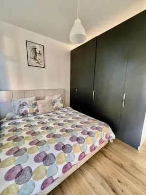 a bedroom with a large bed with a colorful comforter at Bruxnord BnB in Brussels