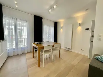 a dining room with a table and chairs at Chapeliers 34 in Brussels