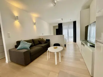 a living room with a couch and a table at Chapeliers 34 in Brussels