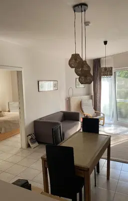a living room with a couch and a table at Appartement dans parc