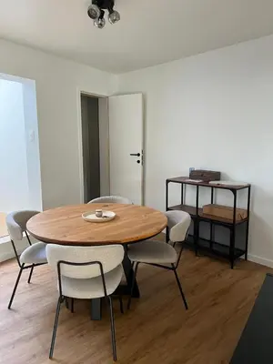 a dining room with a wooden table and chairs at Toverpoort - Seperate room in shared apartment in Ghent