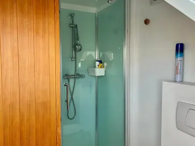 a shower with a glass door in a bathroom at Dock Loft in Ghent