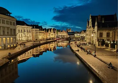 a view of a river in a city at night at Dock Loft in Ghent