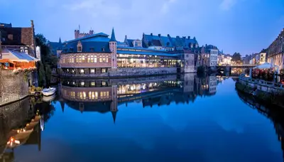 a view of a river with buildings and a bridge at Dock Loft in Ghent