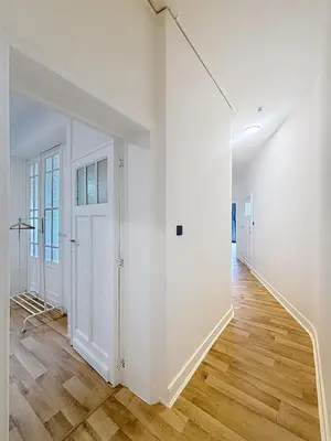 an empty hallway with white walls and wood floors at Basilique Brussels 2 in Brussels