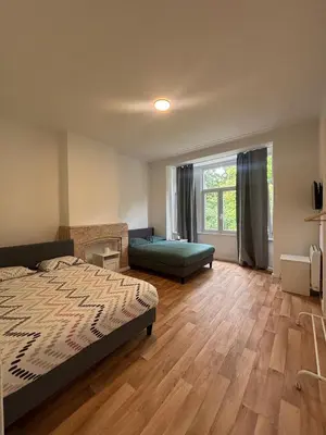 a bedroom with a bed and a large window at Basilique Brussels 2 in Brussels