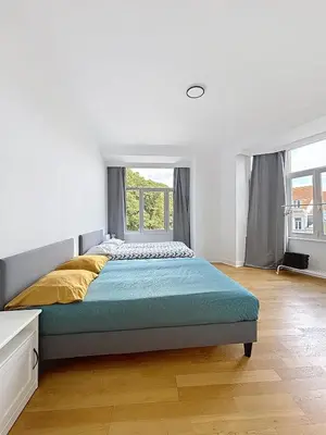 a bedroom with a large bed and a window at Sacre-coeur Brussels 1 in Brussels
