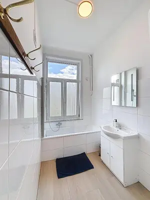 a white bathroom with a sink and a window at Sacre-coeur Brussels 1 in Brussels