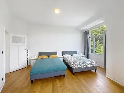 a bedroom with two beds and a window at Sacre-coeur Brussels 1 in Brussels