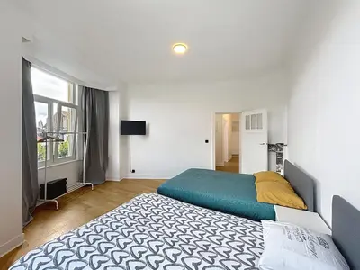 a bedroom with two beds and a window at Elisabeth Brussels 3 in Brussels