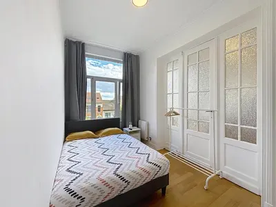 a bedroom with a bed and a window at Elisabeth Brussels 3 in Brussels