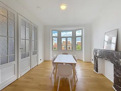 a dining room with a table and chairs and a fireplace at Elisabeth Brussels 3 in Brussels