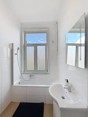 a white bathroom with a sink and a mirror at Elisabeth Brussels 3 in Brussels