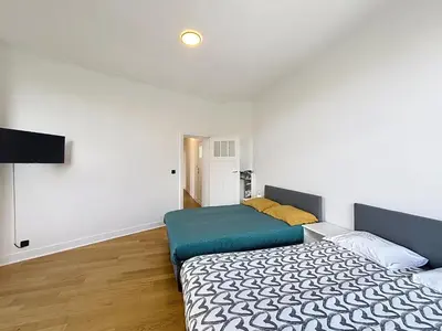 a bedroom with a bed and a flat screen tv at Elisabeth Brussels 3 in Brussels