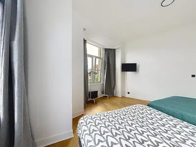 a bedroom with a bed and a window at Elisabeth Brussels 3 in Brussels