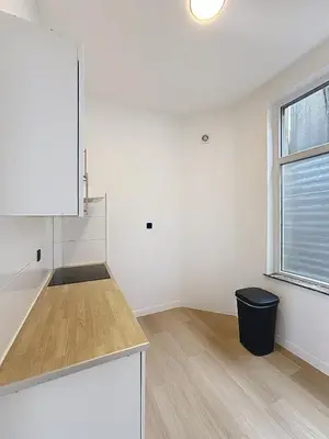 a kitchen with white cabinets and a window at City Brussels 5 in Brussels