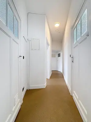 an empty hallway with white walls and doors at City Brussels 5 in Brussels