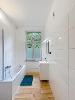 a white bathroom with a tub and a sink at Leopold Brussels 6 in Brussels