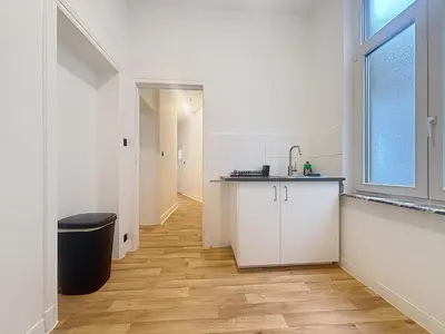 a kitchen with a sink and a counter in a room at Leopold Brussels 6 in Brussels