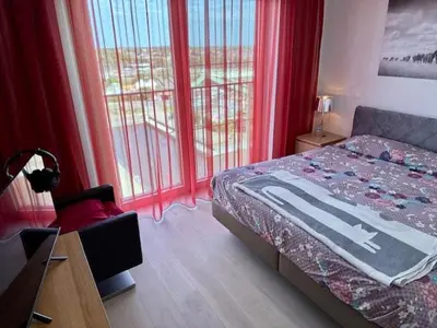 a bedroom with red curtains and a bed and a window at DoK9 in Ghent