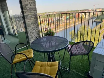 a table and chairs on a patio with a balcony at DoK9 in Ghent