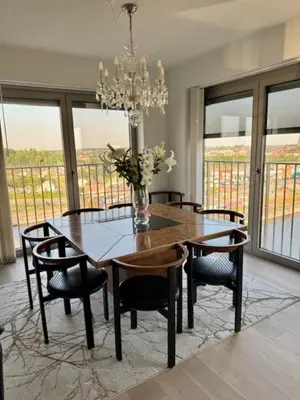a dining room with a table and chairs and a chandelier at DoK9 in Ghent