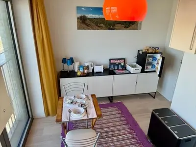 a living room with a table and chairs in a room at DoK9 in Ghent